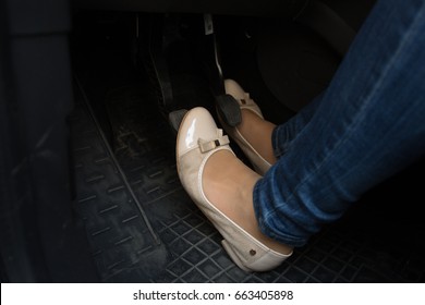 Closeup Of Female Driver Feet On Car Pedals