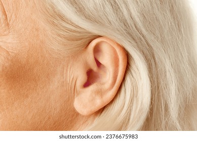 Close-up of female ear. Senior model. Hearing problems and health care, deafness, health check up. Concept of natural beauty, aging process, elderly beauty, cosmetology, skincare - Powered by Shutterstock