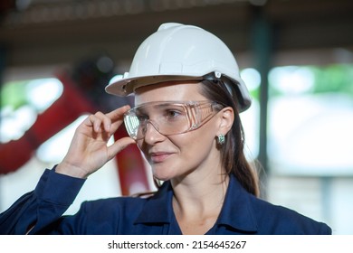 Close-up Of A Female Engineer's Automated Robotic Arm Assembly Line. A Female Engineer With A Strong Commitment To Work.