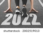 close-up of female feet in sneakers at the start. Beginning and start of the new year 2022, goals and plans for the next year