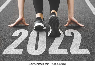 close-up of female feet in sneakers at the start. Beginning and start of the new year 2022, goals and plans for the next year - Shutterstock ID 2002519013