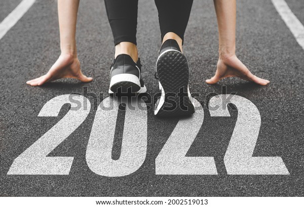 close-up\
of female feet in sneakers at the start. Beginning and start of the\
new year 2022, goals and plans for the next\
year