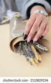 Close-up Of Female Fingers With Heart Nail Art Holding Bouquet