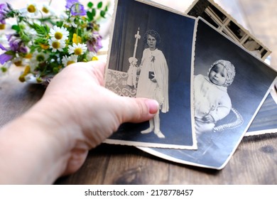 closeup female hand holding old photos of 1940-1950, , concept of family tree, genealogy, childhood memories, memory of ancestors - Shutterstock ID 2178778457