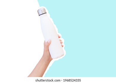 Close-up Of Female Hand Holding Reusable Steel Thermo Water Bottle Isolated On Background Of White And Blue Color.