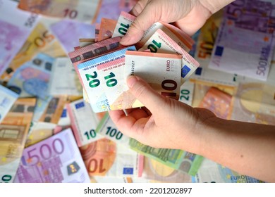 closeup female hands count paper euro banknotes of european union, paper bills on table, concept of cash, payments, savings, banking, save up for vacation, got low salary, social security, pay taxes - Shutterstock ID 2201202897