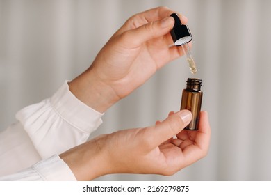 Close-up of female hands holding a bottle of essential oil, Aromatherapy. - Powered by Shutterstock