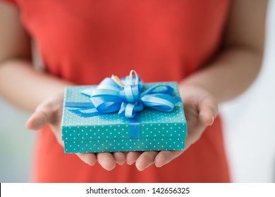 Close-up Of Female Hands Holding A Present