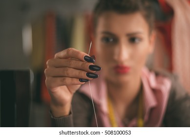 Close-up Of Female Hands Holding Sewing Needle. Vintage Concept. Selective Focus.