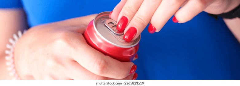 Closeup of female hands opening can of drink