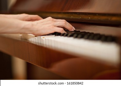 Closeup Of Female Hands Playing The Piano