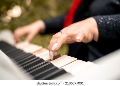close-up female hands playing the piano - Shutterstock ID 2186097001