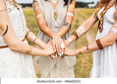 Close-up of female hands, three girls, best friends, flash tattoo, accessories, Bohemian, bo-ho style, indie hippie, ring, bracelet, manicure, feathers
