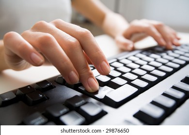 Close-up Of Female Hands Touching Buttons Of Black Computer Keyboard