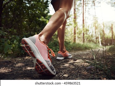 Nahaufnahme weiblicher Wanderfüße, die auf dem Waldweg laufen. Aktive Frau Rucksacktouristen auf der Natur. 