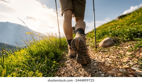 Close-up of female hikers legs walking on a mountain trail with trekking poles and wildflower mountain landscape in the german alps - Powered by Shutterstock