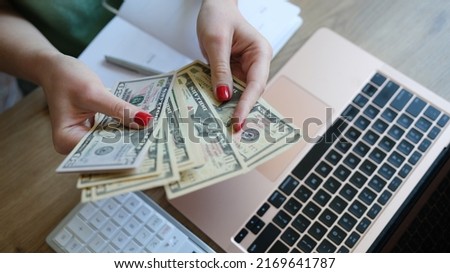 Close-up of female holding cash in hand and counting banknotes. Earned money, savings and earnings concept. Financial accounting plan