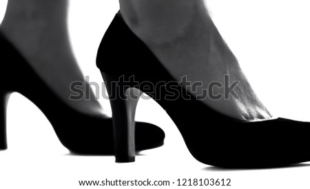 Closeup of female legs in high-heeled shoes, feminism concept, womens rights