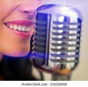 Close-up Of Female Mouth Singing Into Vintage Microphone.