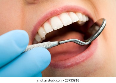 Close-up Of Female With Open Mouth During Oral Checkup At The Dentist?s