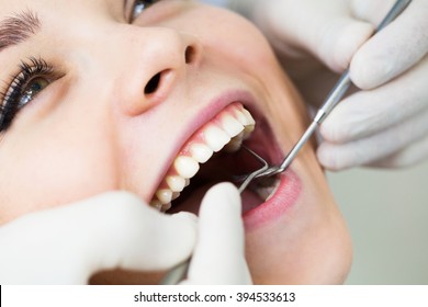 Close-up Of Female With Open Mouth During Oral Checkup At The Dentist.Dentist