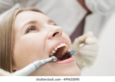 Close-up Of Female With Open Mouth During Oral Checkup At The Dentist.Dentist