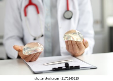 Close-up Of Female Plastic Surgeon Holding Silicone Implants In Hands. Plastic Surgery, Breast Augmentation And Beauty Concept