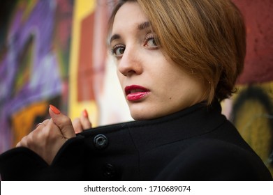 Close-up Female Portrait Of Young Smiling Girl With Short Blonde Hair Near The Wall With Graffiti. Youth Culture, Street Art Concept