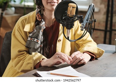 Close-up Of Female Radio Dj Speaking In Microphone Sitting At Her Workplace During Broadcasting At Radio