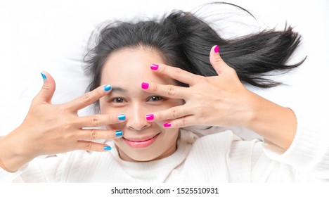 Close-up Of Female Showing Hands Paint Nail Varnish With Smiley Face, Self Made Manicure At Home.