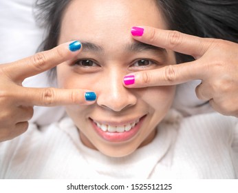 Close-up Of Female Showing Hands Paint Nail Varnish With Smiley Face, Self Made Manicure At Home.