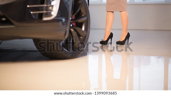 Close-Up Female Toes. Woman on Black High Heels\
Near Luxury Vehicle in Car Showroom. Business Lady in Dress is\
Going to Buy New Car in Auto Show. Kyiv, Ukraine, F-Drive showroom\
13 of february 2018.