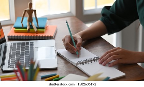 Closeup female writing or sketch on notepad paper. - Shutterstock ID 1582636192
