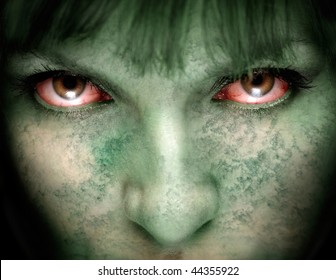 Closeup of female zombie face with bloodshot eyes and green skin