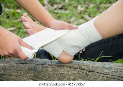 Closeup Females Injured Ankle, Getting Bandage Compression Wrap