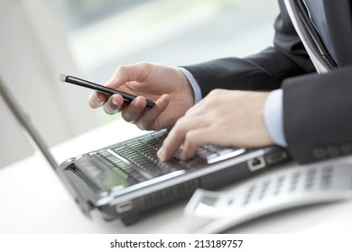 Close-up Of Financial Advisor Analyzing Data While Using His Mobile Phone. Business People. 