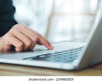 Close-up finger of business person in suit touch on touchpad on laptop computer. Working on notebook, business technology concept. Control your digital world with just your fingertips. - Shutterstock ID 2249882829