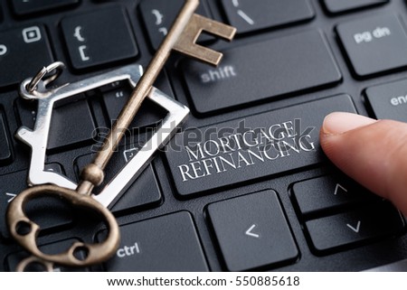 Closeup of finger on keyboard with words Mortgage Refinancing