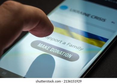 Close-up Finger Pressing Make Donation Button On Smartphone Screen. Donation Money Online Concept