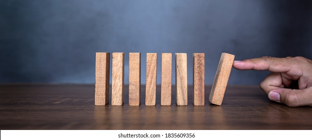 Close-up Fingers Prevent The Wooden Block Jenga Game Stick From Falling Domino Concepts Of Financial Risk Management And Strategic Planning.