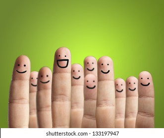 Close-up Of Fingers With Smiley Face Isolated On Green Background