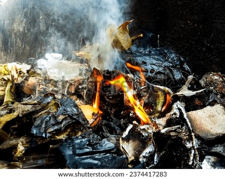 closeup of fire from burning rubbish.  pile of rubbish being burned.  burning fire.