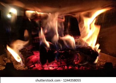 Close-up of fire and flames in a fireplace at home. - Shutterstock ID 1244358055