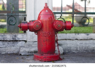 Close-Up Of Fire Hydrant At Sidewalk. Red fire hydrant