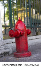 Close-Up Of Fire Hydrant At Sidewalk. Red fire hydrant