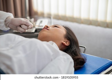 Close-up First Aid emergency the injured patient faint with ammonia inhalation, Unconscious young Asian woman in emergency room. - Powered by Shutterstock