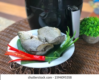 Closeup Fish Grilled With Air Fryer In The White Plate On The Rattan Table.Ready To Eat.Outdoor,balcony,garden.