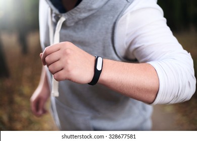 Closeup Of Fitness Bracelet During Park Jog