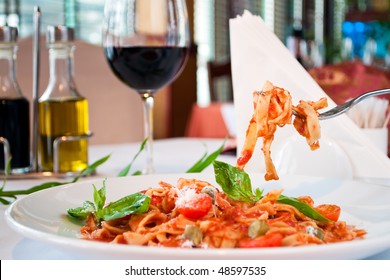 closeup of a fituchini served up with sauce and cherry tomatoes - Powered by Shutterstock