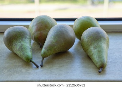 Close-up Of Five Pears Lying On The Sunny Windowsill